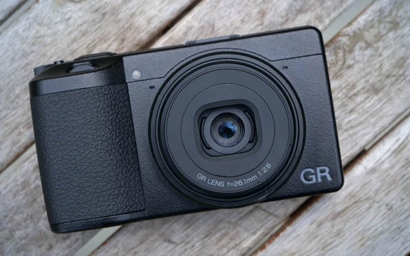 Black Ricoh GR IIIx on a wooden surface