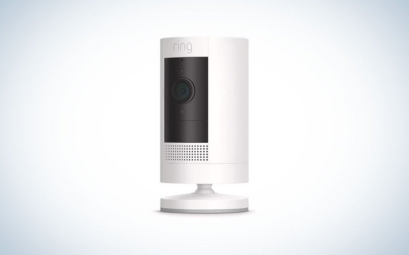 A white Ring wireless stick up camera on a plain background